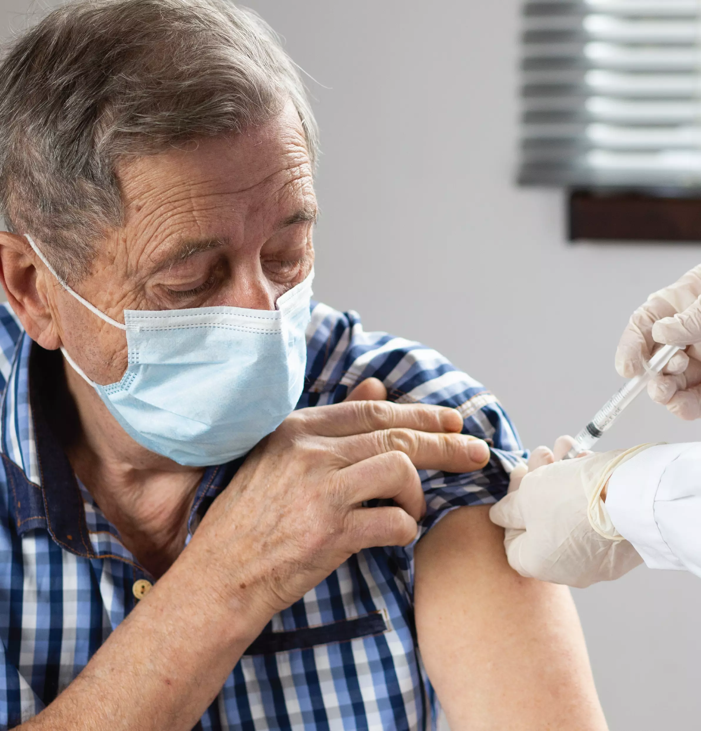 Pharmacist giving man a shot