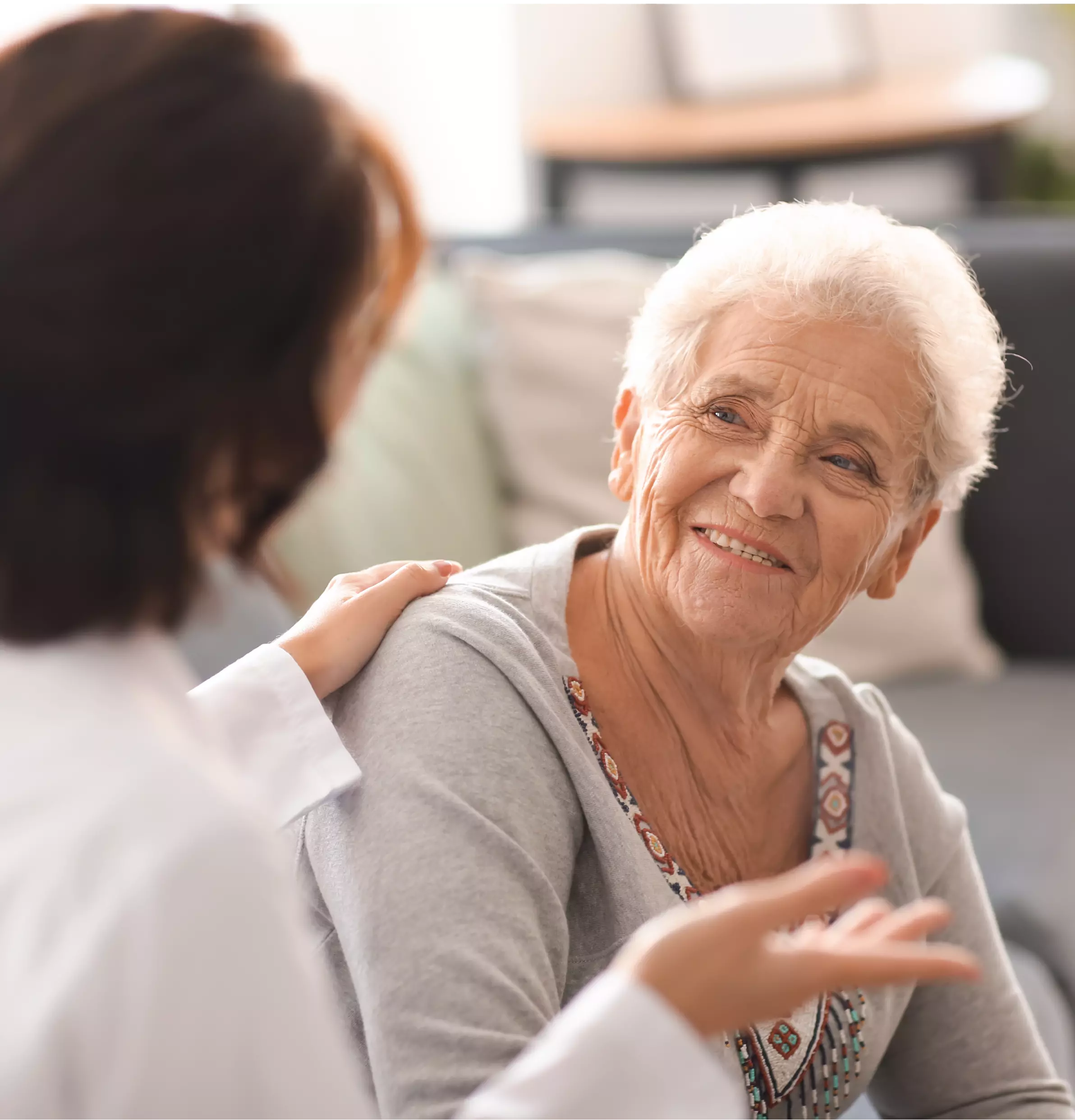 pharmacist speaking to elderly woman