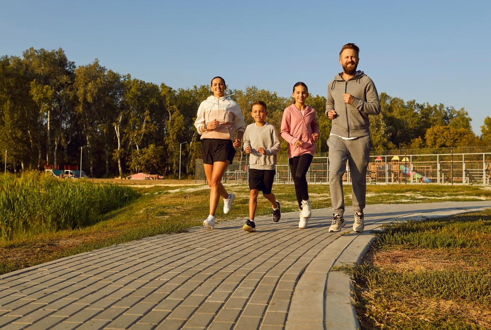 family of 4 running together outside for exercise