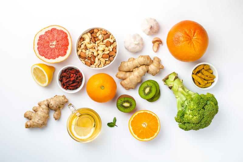 assorted foods to boost immunity including citrus, broccoli, ginger, and nuts