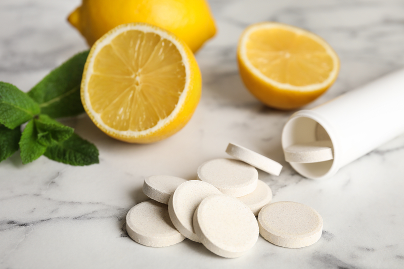 vitamin C tablets next to lemons