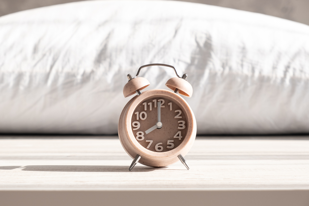 alarm clock in front of pillow