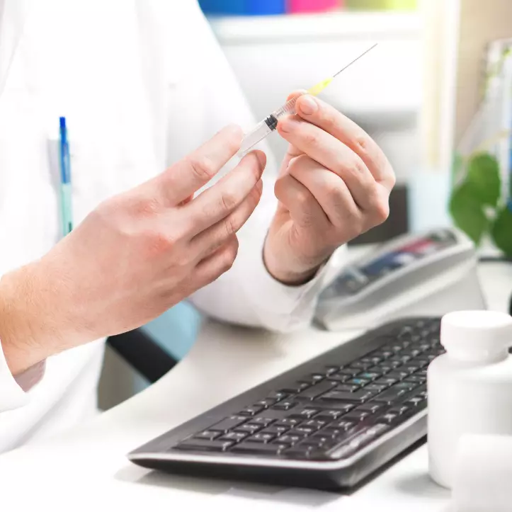 doctor drawing up medicine in a needle 