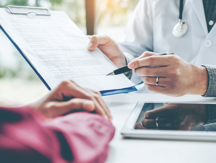 doctor and patient filling out paperwork 