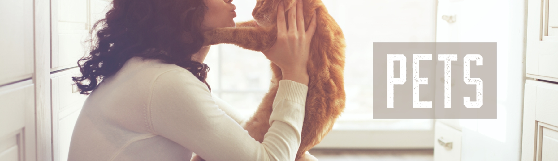 woman holding dog Pets header 